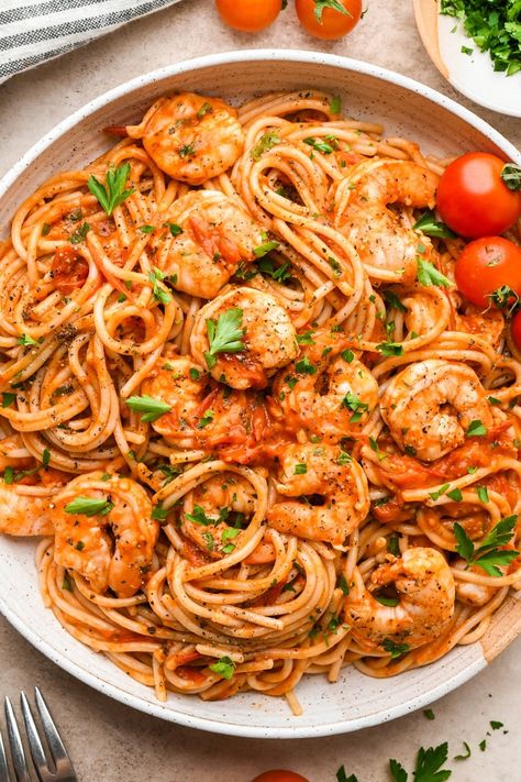 This simple burst cherry tomato and shrimp pasta is so simple but so incredibly flavorful! Made with fresh cherry tomatoes, lots of garlic, and a little bit of tomato paste to bolster the tomato flavor, it is made without cream and dairy free. We opt for GF pasta to keep the recipe gluten free, but any pasta you like will work! It is all cooked in one skillet and ready in just 30 minutes. Adding chopped parsley brings some color and elegance to the dish, making it just as perfect for serving guests as it is for a quick weeknight dinner. Tomatoe Shrimp Pasta Recipes, Shrimp Cherry Tomato Pasta, Pasta Sauce With Cherry Tomatoes, Shrimp Tomatoes Pasta, Blistered Cherry Tomatoes Pasta, Shrimp And Tomato Pasta, Grape Tomato Recipes Pasta, Shrimp Sun Dried Tomato Pasta, Pasta Recipes With Cherry Tomatoes