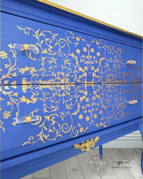 Transform your space with this stunning, one-of-a-kind chest of drawers, meticulously painted using Annie Sloan Chalk Paint in the captivating color "Frida Blue." This rich and vibrant blue hue exudes charm and sophistication, adding a bold yet classic touch to any room. The piece is adorned with intricate gold accents using a beautiful Decor Transfer, creating a luxurious floral design that enhances its timeless appeal. With two spacious drawers, this chest offers ample storage for all your... Blue And Gold Furniture, Foil Decor, Gold Furniture, Golden Pattern, Annie Sloan Chalk Paint, Match Making, Annie Sloan, Vibrant Blue, Blue And Gold