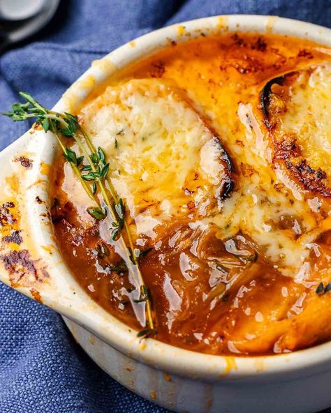 French onion soup is as delicious as it is beautiful! This comfy soup combines caramelized onions simmered in a rich beef-vermouth broth and served in crocks topped with sliced baguette and melted Gruyere cheese. This soup tastes even better when made ahead of time making it a great option for gatherings! #frenchonionsoup #caramelizedonions #onionsoup Sip And Feast Recipes, Homemade French Onion Soup, Sip And Feast, Feast Recipes, Rainy Fall, French Onion Soup Recipe, Beef Barley Soup, Onion Soup Recipes, Tomato Broth