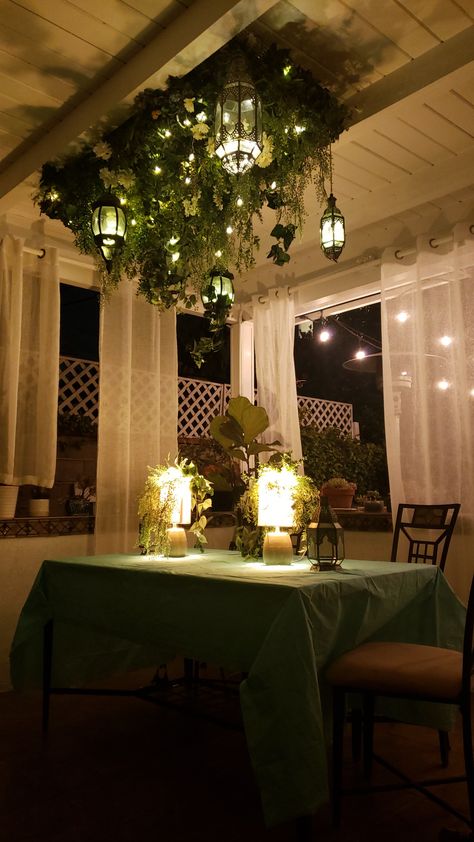 Wanted to make an interesting ceiling centerpiece for my outdoor patio party. The ceiling centerpiece base is 19g chicken wire held up by hooks fastened to the ceiling. I happened to have a ton of fake plants around the house so I zip tied it to the base. Added the string lights as an extra. Faux Greenery Ceiling, Fake Ceiling Plants, Greenery Ceiling Bedroom, Plant Ceiling Light, Fake Plant Ceiling, Greenery On Ceiling, Faux Plant Ceiling Decor, Greenery On Pendant Lights, Faux Plant Ceiling