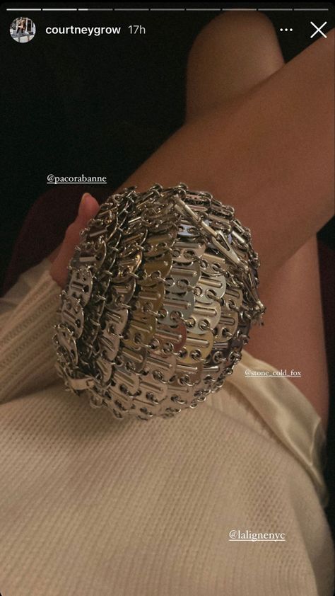 paperclip silver bag clutch small handbag with a cream colored outfit pairing of sweater and silk satin skirt paco rabanne, paco rabanne 60s, paco rabanne bag, paco rabanne 2023, paco rabanne bag outfit, paco rabanne bag street style, paco rabanne bag 1969, paco rabanne bag aesthetic summer bags, summer bag essentials, summer bags 2023, summer bags beach, summer bags handbags, summer bag aesthetic, summer bags 2023 trends, summer bag outfit courtney grow street style Summer Bags 2023, Summer Bag Outfit, Summer Bags Handbags, Bags 2023 Trends, Paco Rabanne 60s, Paco Rabanne Bag, Courtney Grow, Summer Bag Essentials, Bag Street Style