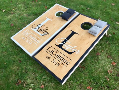 Wedding Cornhole Boards  Quality Materials, Excellent Craftsmanship and Attention to Detail will set our cornhole boards apart from the competition.  Crisp Clean Vibrant Paint job - no decals peeling, lifting or fading that you get with most vinyl wrapped cornhole boards.  Flush Seams, Sanded Surfaces, Perfectly Routered Holes and Sides will give your Cornhole Boards a Professional Look.    🇺🇸 Made in the U.S.A. Tournament Style Boards * Regulation Size meets ACA specs * Pocket Hole Joinery * Wedding Cornhole Boards, Outdoor Yard Games, Wedding Cornhole, Cornhole Boards Designs, Cornhole Designs, Pocket Hole Joinery, Custom Cornhole Boards, Weddings By Color, Bag Toss