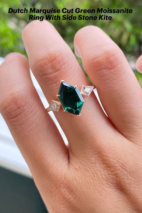 Looking for the perfect engagement ring? This dark green marquise simulated diamond ring is a dazzling choice. The sparkling simulated diamond is set in a delicate white gold band, creating a timeless and elegant look. Say "I do" with this gorgeous ring. #simulateddiamond #ring #marquise #dutch #darkgreen #diamond #engagementring #solitaire #whitegold Dutch Marquise, Ring Hexagon, Hexagonal Ring, Smaragd Ring, May Birthstone Rings, Green Emerald Ring, Yellow Gold Engagement Ring, Engagement Ring For Her, Simulated Diamond Rings