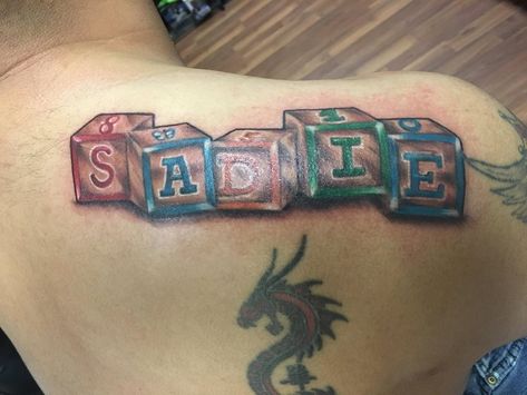 Toy Blocks name tattoo by Mike Hepler Block Name Tattoo, Birthdate Tattoo, Father Son Tattoo, Tattoo Baby, Biblical Tattoos, Hanya Tattoo, Kid Name Tattoo, Glyph Tattoo