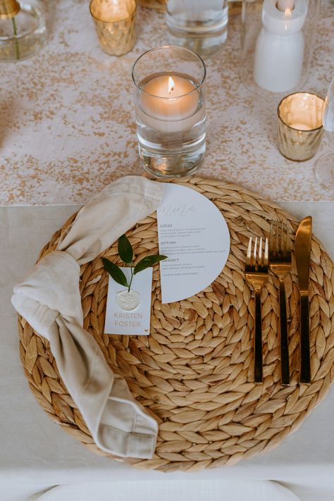 Rattan Wedding Table Decor, Woven Chargers Table Settings Wedding, Tall Candle Centerpiece, Gold Charger Sage Napkin, Sage Napkins Gold Chargers, Rattan Chargers Table Setting Wedding, Burgundy Ranunculus, Sahara Rose, Hanging Greenery