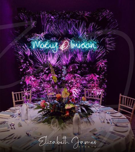 Incredible Wedding Backdrop for Marcus & Imraan ⚡️🌿💖 Working with the wonderful @lndevents, we created a Custom Neon Sign (in the couple's very own handwriting), hung it from our Extra Tropical Foliage Wall and added our Pink Uplighters for this epic Miami-Vice inspired full backdrop ⚡️🌿💖 Epic floral table centrepieces by @hydeparkflowerclub.by.dotties 🌺 Photos with thanks to @leahweddings 📷 Miami Vice Wedding, Tropical Backdrop, Luxury Event Decor, Foliage Wall, Balloon Installation, Elizabeth James, Wedding Event Decor, Light Up Letters, Floral Table