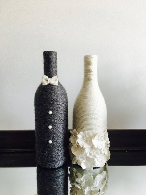 Congratulations to the newly engaged couple! These wine bottles are wrapped in charisma yarn and polished off with embellishments to represent the bride and groom. Display them at your engagement party, bridal shower and wedding! The price reflects ONE wine bottle so you can choose what fits Wine Bottle Wedding Centerpieces, Bridal Shower Pictures, Cheap Wedding Table Centerpieces, Bottle Decorations, Wine Bottle Centerpieces, Wedding Wine Bottles, Bridal Shower Decorations Diy, Bottle Centerpieces, Wedding Gifts For Bride And Groom