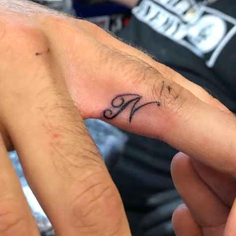 Ring finger tattoo initial ‘N’ Finger Tattoo Initial, Ring Finger Tattoo, N Tattoo, Ring Tattoo, Tattoo Spots, Tattoos Infinity, Tato Jari, Finger Tattoo For Women, Ring Finger Tattoos