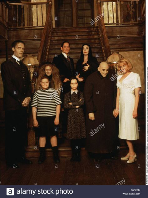 Download this stock image: RELEASE DATE: 22 November 1991. MOVIE TITLE: The Addams Family - STUDIO: Paramount Pictures. PLOT: Con artists plan to fleece the eccentric family using an accomplice who claims to be their long lost Uncle Fester. PICTURED: CAREL STRUYCKEN as Lurch with JIMMY WORKMAN as Pugsley Addams, JUDITH MALINA as Grandma, RAUL JULIA as Gomez Addams, CHRISTINA RICCI as Wednesday Addams, ANJELICA HUSTON as Morticia Addams, CHRISTOPHER LLOYD as Uncle Fester and JOAN CUSACK as Debbie Uncle Fester And Debbie, Uncle Fester And Debbie Costume, Wednesday Addams And Xavier, Wednesday And Pugsley Addams, Carel Struycken, Addams Family Film, Wednesday Addams Party Ideas, Wednesday Addams Party, Wednesday Addams Birthday