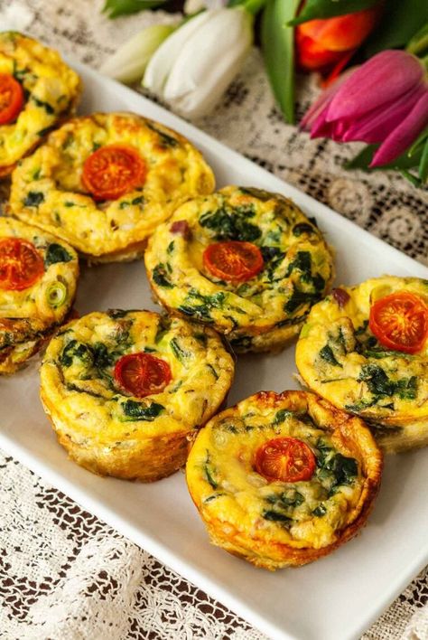 These Mini Quiches with Ham and Swiss have half the pastry as traditional mini quiches, with all of the delightful, savory flavors! This bite-sized recipe works wonderfully as either an appetizer or main course for a brunch party, and looks so beautiful, topped with colorful cherry tomatoes! With about 40 minutes of cook time and only 20 minutes prep, they’ll be ready to serve or store for tomorrow’s breakfast or brunch! Individual Quiches With Crust, Individual Quiche Recipes, Chicken Quiche, Mini Quiche Recipes, Tomato Quiche, Ham And Swiss, Ham Steaks, Mini Quiches, Cheese Quiche