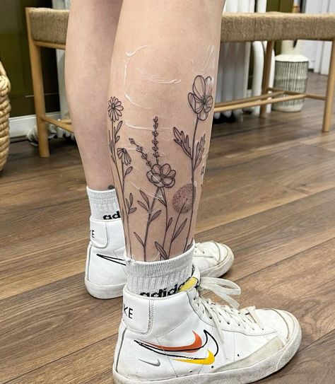 Flower Tattoo On Back Of Leg, Shin Wrap Around Tattoo, Lilly Leg Tattoos Women, Flower Tattoos Calf, Wrap Around Tattoos For Women Leg, Floral Ankle Band Tattoo, Flower Garden Tattoo Ankle, Flowers On Shin Tattoo, Flowers On Legs Tattoo