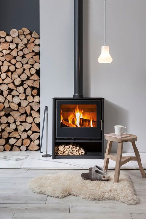 Scandinavian Fireplace Ideas and Inspiration | Hunker Scandinavian Fireplace Ideas, Contemporary Wood Burning Stoves, Scandinavian Fireplace, Wood Burning Stoves Living Room, Modern Wood Burning Stoves, Log Burning Stoves, Freestanding Fireplace, New Interior Design, Hygge Home