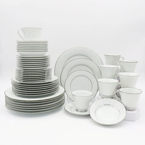 "Noritake Ranier is an exquisite formal china pattern, featuring a chic white-on-white floral design and platinum trim. This clean, understated design gives you the flexibility to dress your settings \"up\" or \"down,\" whether you're planning a formal dinner party or a casual brunch. Embossed Lace Flowers, Platinum Trim Gorgeous and delicate white flowers and Silver Trim encircle the fine and elegant white background. Pattern Number: 6909 Discontinued. Actual: 1969 - 1996 Free of any chips, cra Noritake China Patterns Vintage, In Law Wedding Gifts, Noritake China Patterns, Grandma Of The Bride, Formal Dinner Setting, Wedding China, Noritake China, Formal Dinner, China Sets