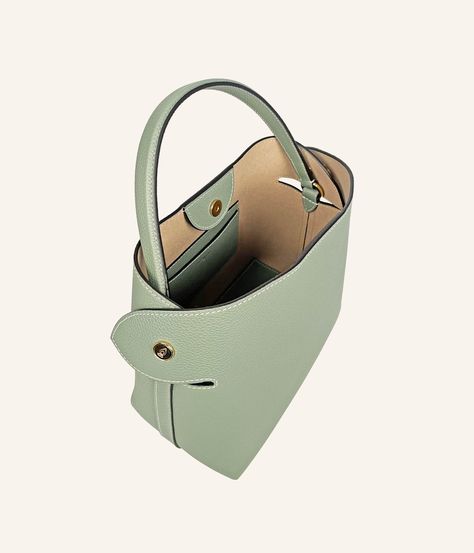 The Almond Green, soft and poetic, is perfect for accompanying your everyday outfit or for accentuating a more formal look. This high-quality grained leather handbag, crafted in our Italian workshop, is as practical as it is aesthetic, with ample space to hold your essentials, a good book, and your sunglasses. Chic Epsom Leather Shoulder Bag With Soft Leather, Luxury Textured Leather Bucket Bag For Daily Use, Luxury Soft Leather Bucket Bag For Office, Designer Textured Leather Tote Bucket Bag, Classic Office Bucket Bag With Leather Lining, Classic Leather-lined Office Bucket Bag, Luxury Bucket Bag Satchel For Office, Luxury Satchel Bucket Bag For Office, Chic Epsom Leather Shoulder Bag With Leather Lining