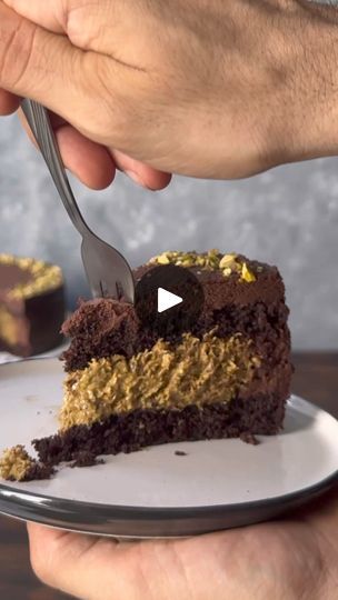 This chocolate pistachio cake is inspired by the viral Dubai chocolate bar. It features 2 moist chocolate cake layers, an amazing filling with a homemade white chocolate and pistachio cream mixed with crunchy kataifi pastry, and a whipped chocolate ganache frosting. It's one of the best desserts you'll ever have!
https://www.thehungrybites.com/chocolate-pistachio-cake/ | The Hungry Bites Dubai Chocolate Cake, Chocolate Pistachio Cake, White Chocolate And Pistachio, Dubai Cake, Chocolate Bar Cakes, Chocolate Cake Layers, Kataifi Pastry, Homemade White Chocolate, Dubai Chocolate