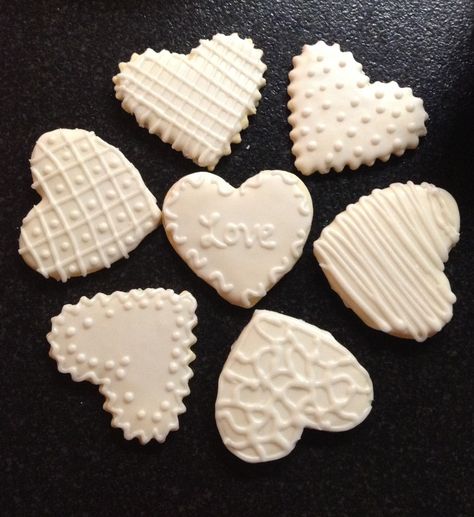 White heart sugar cookies perfect for weddings or valentines day! White Heart Cookies Royal Icing, Bridal Shower Heart Cookies, Heart Shaped Wedding Cookies, White Royal Icing Cookies, Wedding Heart Cookies, Heart Wedding Cookies, Simple Wedding Cookies, Wedding Cookies Decorated Simple, Wedding Sugar Cookies