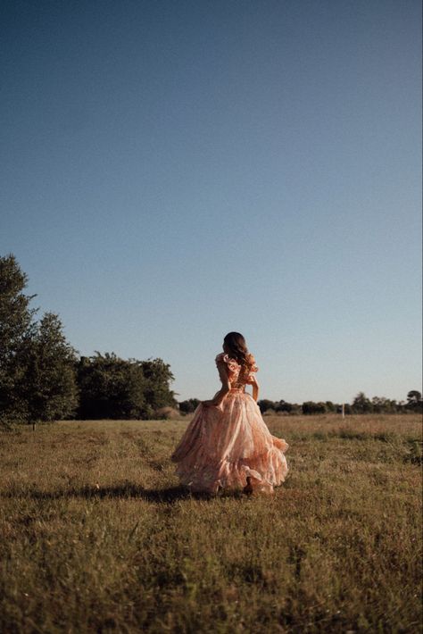 running away from the camera in a grass field. Grad Dress Picture Ideas, Romantic Senior Pictures, Landscape Photography With People, Field Prom Pictures, Photoshoot Ideas Long Dress, Big Dress Senior Pictures, Birthday Photoshoot Dress Ideas Outfit, Frolicking In A Field Dress, Royal Photoshoot Ideas