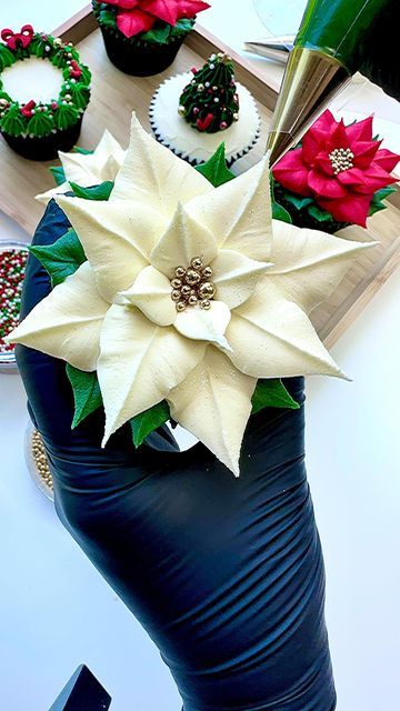 @cakestone20 on Instagram: "A white buttercream poinsettia from our Christmas cupcake piping series 🧁🤍 🎄 We hope you are enjoying these as we are having a lot of fun doing them! ☺️ #reels #reelsofinsta #reelitfeelit #bakingreels #christmastime #reellife #cupcakereels #trendingreels #oddlysatisfying #christmascupcakes #christmascake #whitepoinsettia #poinsettiacupcakes #cakedecorating #cakedecoratingreel #cakereel #cakereels #bakingreels #satisfyingvideos #buttercreampiping #engagement #explorepage #christmasiscoming #cakestone #cakestone20 #reelvibes #reelcreator" Buttercream Poinsettia, Cupcake Piping, Cookie Decorations, White Buttercream, Christmas Cupcake, Holiday 2024, Christmas Foods, Mary Berry, Christmas Cupcakes