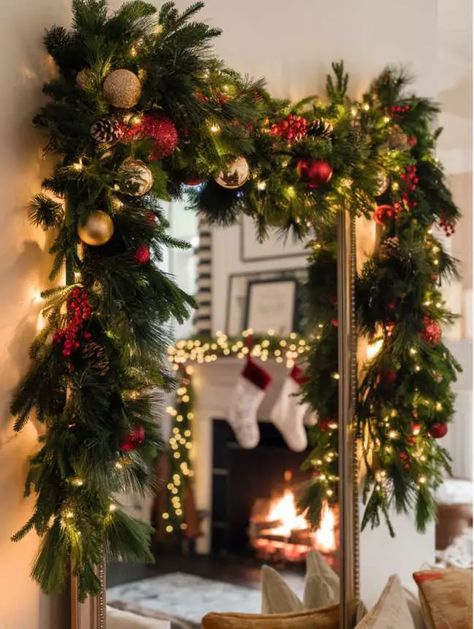 Festive Garlands Gold Mirror Christmas Decor, Christmas Garland Over Mirror, Large Window Christmas Decorating Ideas, Christmas Garland Mirror, Decorate Mirror For Christmas, Apartment Porch Christmas Decor, Mirror Garland Christmas, Mirror Christmas Decor Ideas, Christmas Mirror Decor