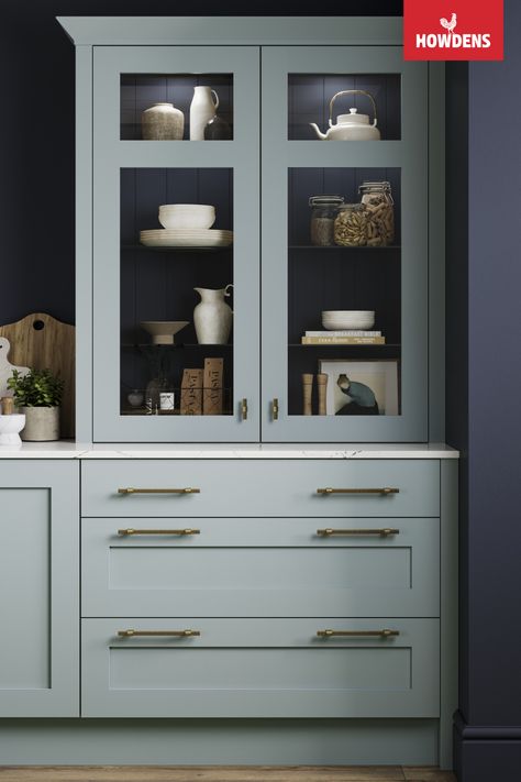 Embrace classic elegance in your kitchen with our traditional design. Our striking blue shaker cabinets paired with a pristine white quartz countertop set the stage for culinary inspiration. The Howdens Chilcomb Seafoam Glass Dresser adds a touch of timeless charm, while brushed brass kitchen hardware enhances the overall appeal. Dive into blue kitchen ideas and create your culinary haven with Howdens Joinery. Seafoam Kitchen, Brushed Brass Kitchen Hardware, Howdens Chilcomb, Brushed Brass Kitchen, Blue Kitchen Ideas, Shaker Drawer Fronts, Blue Shaker Cabinets, Brass Kitchen Hardware, Howdens Kitchens