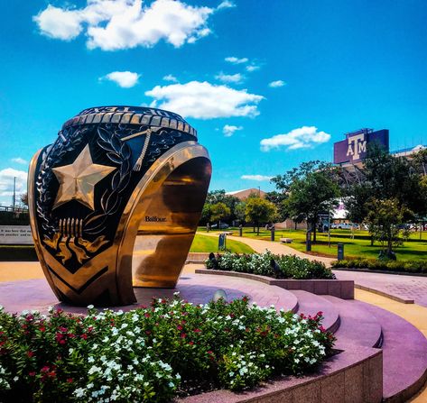 The Aggie Ring is 12 feet tall, made of real metal, and designed for photo-ops. It's a replica of a Texas A&M University ring, specifically the ring of Harold Bill Haynes, the namesake of the plaza. The seal on the top of the ring bears his class year is the time capsule inside to be opened in 2046. It was unveiled Sept. 18, 2009. see if your ring can fit the size, it’s on 505 George Bush Drive in College Station, Texas. #roadattractions #roadsidefunk #classring #collegestation #texas Texas A&m Corpus Christi, A&m College Station, Texas A&m University, A&m Football, Aggie Ring, Gig Em Aggies, College Vision Board, College Station Texas, Texas A M University