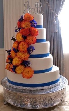 Blue and orange wedding cake Royal Blue And Orange Wedding, Blue Wedding Cake Designs, Royal Blue Wedding Cake, Orange And Blue Wedding, Royal Blue Wedding Cakes, Blue And Orange Wedding, Blue Orange Weddings, Orange Wedding Cake, Blue Wedding Cake