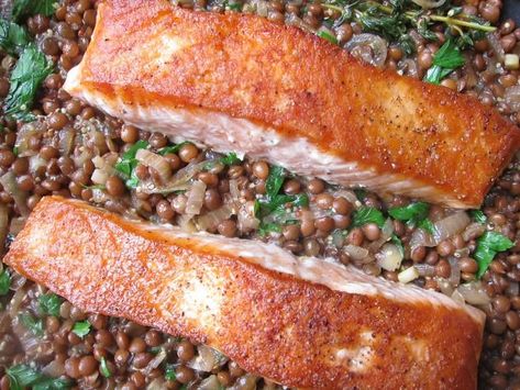 Salmon and lentils is to France what peas and carrots is to the States: an absolutely classic pairing. In this simple, satisfying one-pot dinner that plays off the famous couple, crispy salmon is served in a broth of lentils flavored with caramelized shallots and mustard. Salmon And Lentils, Healthy Salmon Dinner, Crispy Salmon, Caramelized Shallots, Healthy Salmon, Salmon Dinner, One Pot Dinner, Two Fish, Lentil Recipes