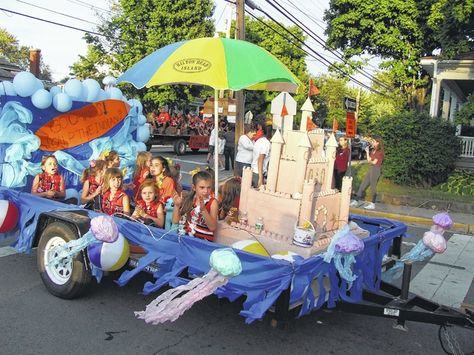 With a theme of “Seaside Paradise,” the floats and parade units were appropriately bathed in sunshine Thursday evening for the annual Wilmington City Schools Homecoming Parade. Participants — and there were many — made use of sunglasses, nose sunblocks, beach towels, inflatable or handmade palm trees, Hawaiian leis, beach balls, and, well you get the [...] Kids Parade Floats, Holiday Parade Floats, Parade Float Theme, Halloween Parade Float, Mermaid Float, Carnival Floats, Beach Floats, Tailgate Ideas, Christmas Parade Floats