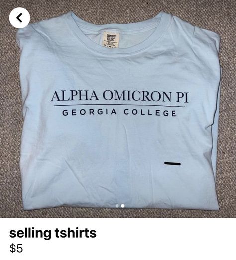 this is a photo of a light blue sorority shirt that reads “alpha omicron pi” then a line underneath. under the like it says “georgia college”, but this can be replaced by any university. it is a simple design, and the words are stitched in either black or dark brown print. Simple Sorority Shirts, Simple Shirt Designs, Simple Shirt Design, Sisterhood Round, Soccer Tshirt, Big Little Shirts, Sorority Shirt, Alpha Omicron Pi, Alpha Xi Delta