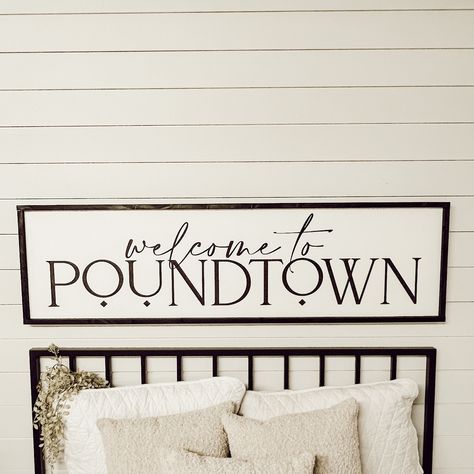 "welcome to poundtown  Free shipping in the continental U.S. White background with black lettering and your choice of frame color.  (to change the background or lettering color, put a note in the comment section at checkout) The 3D elements offer a bolder dimensional look and are made from 1/4\" laser cut boards, and are securely attached to the sign. The standard (not 3D) option offers a softer feel with all lettering painted. Available in 6 sizes: Shelf size - 7.5\" x 25.5\" x 1.5\" Twin size - 10.5\" x 37.5\" x 1.5\" Queen size - 13.5\" x 49.5\" x 1.5\" Queen Large -17.5\" x 49.5\" x 1.5\" King size - 13.5\" x 66\" x 1.5\" King Large - 17.5\" x 61.5\" x 1.5\" (give or take half an inch on all dimensions) Each sign has two claw hooks for easy hanging.  I will do my absolute best to get y Above The Bed Decor Master, Bed Signs Wall Art, Sign Over Bed Master Bedrooms, Diy Over The Bed Wall Decor Ideas Master Bedrooms, Newly Married Bedroom Ideas, Welcome To Poundtown Sign, Guest Room Wall Decor Ideas, Wall Decor Bedroom Above Bed Master Suite, Poundtown Sign