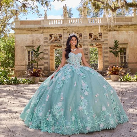 PR30133. Description: The bodice of this gown is a work of art in itself, adorned with 3D appliqués that weave a tapestry of floral motifs, enhancing the gown's femininity and charm.The lace extends into the voluminous skirt, which billows and flows with every step you take, creating a regal aura fit for a princess. Enjoy the included matching cape and detachable bow to complete your look. Teal Quinceanera Dresses, Quinceanera Themes Dresses, Quinceñera Dresses, Mary's Bridal, Pretty Quinceanera Dresses, Quinceanera Themes, Manufacturing Factory, Quince Dress, Dresses Quinceanera