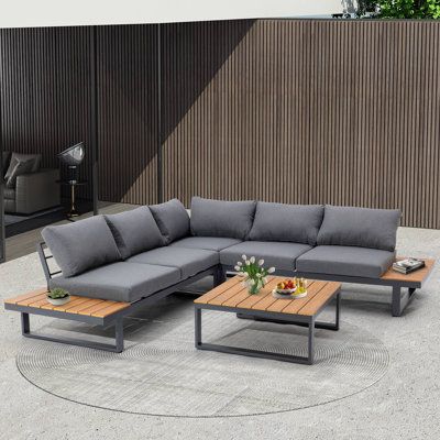 Entertain on the patio or porch with this four-piece sectional set! Including two loveseats, one corner section, and one coffee table, each piece in this set is crafted of powder-coated aluminum in a weather-resistant finish. Featuring delightful built-in side tables, our sectional set offers plenty of space for you to conveniently place your chilled drinks and snack, allowing you to lounge outside all summer. Finished with a classic slat-top coffee table, this set will be your to-go spot for so Outdoor Patio Sectional, Patio Seating Sets, Sofa Seating, Patio Sectional, 3 Piece Sectional, Coffee Table Wayfair, Sofa Seats, Grey Cushions, Patio Seating