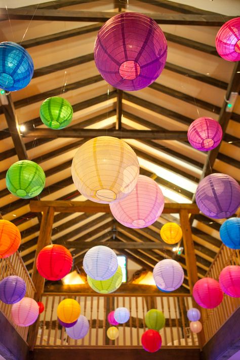 Bright coloured paper lanterns really enlighten this dark beamed venue, this bride picked all the colours of the rainbow! Very funky! Hanging Paper Lanterns Classroom, Lanterns In Bedroom, Rainbow Lanterns, Colourful Decorations, Pride Decorations, Hanging Party Decorations, Marquee Decoration, Carnival Baby Showers, Cocktail Party Decor