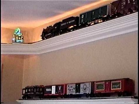 O scale model train shelf layout.  This is an updated video to show the following additions to my layout:     - added rope lighting behind the track  - added scale neon signs in the four corners  - upgraded the train to a smoother, larger one, with sound  - added "display" shelving for my extra train and cars  - connected all the controls to a w... Train Shelf, Train Bedroom, Model Train Display, Rope Lighting, Model Train Table, Model Train Accessories, Train Table, Train Miniature, Train Room