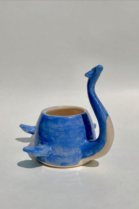 Lochness Monster, Monster Animal, Cozy Reading Chair, Ceramic Monsters, Ceramic Cafe, Dinosaur Mug, Chair Ideas, Pottery Pot, Ceramic Pieces