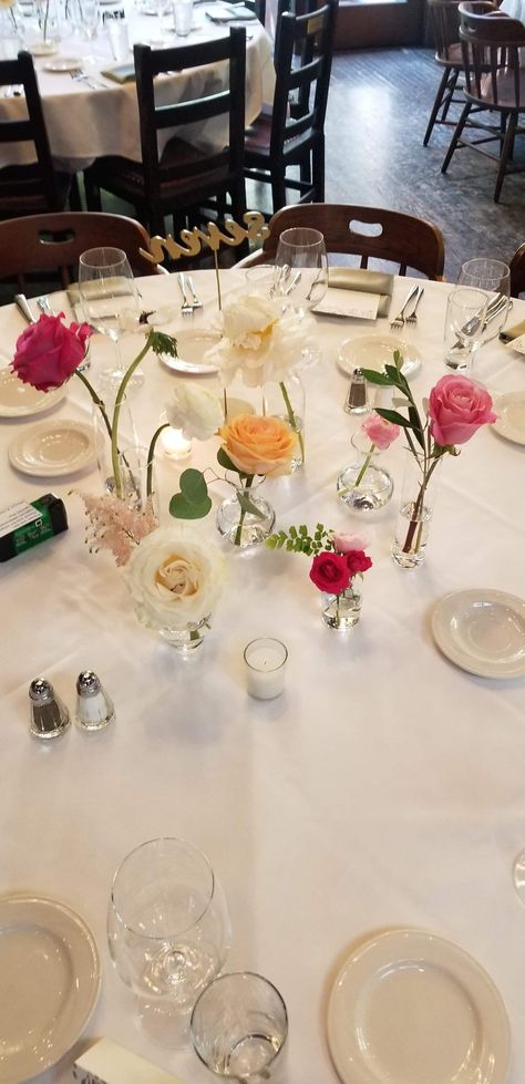 Single Vases Centerpiece, Small Rose Vase Arrangements, Rose Bud Vase Arrangements, Small Vase And Candle Centerpiece, Single Flower Vases Centerpiece, Single Flowers In Vases Wedding, Cylinder Bud Vase Centerpiece, Rehearsal Dinner Bud Vases, Single Bud Vases Wedding Centerpiece