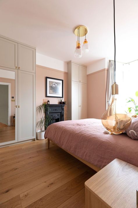 A stunning bedroom renovation in off peach walls, pink bedding and timber furniture, adding warmth to the main bedroom. The elegancy of the Tala pendants hanging either side of the bed for decorative + focal lighting adds to the character of the room. Read more about this project here! Do you need help with your London or Brighton renovation? Contact us now! Renovation by Absolute Project Management, photography by Moon Street Studio. #renovation #bedroom #interiordesign #aesthetic #art #pink Aesthetic Art Pink, Complete House Renovation, Renovation Bedroom, Reclaimed Fireplace, Studio Renovation, Bifold Patio Doors, Contemporary Design Style, Peach Walls, Flooring Inspiration