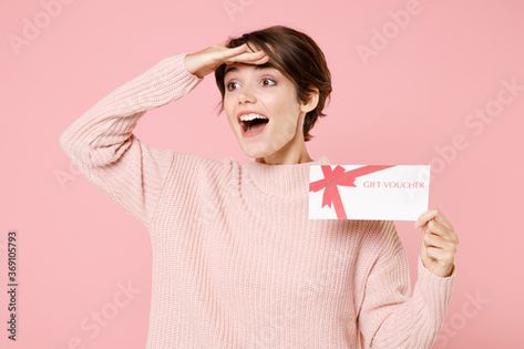 Stock Image: Excited young brunette woman in knitted casual sweater posing isolated on pastel pink background. People lifestyle concept. Hold gift certificate holding hand at forehead looking far away distance. Pastel Pink Background, Brunette Woman, Casual Sweater, Gift Certificate, Studio Portraits, Casual Sweaters, Girls Wear, Pink Background, Pastel Pink