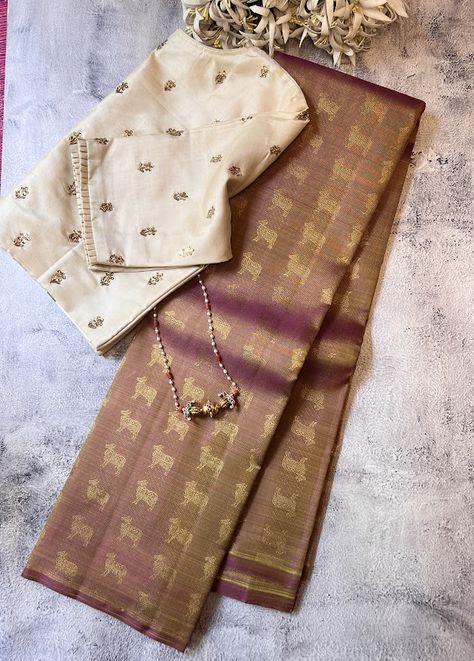 Meera mauve kamadhenu silk saree  A signature Aavaranaa creation.  The body has the kamadhenu motifs woven in pure zari  The pallu has mythical creatures and rudrakshams woven in pure zari Stunning play of colours in a shot colour format  To view other kanchipuram sarees, please click on   https://aavaranaa.com/kanchipuram-silk-sarees/ Saree Kanchipuram, Silk Saree Kanchipuram, Sari Blouse Designs, Elegant Blouse Designs, Sari Blouse, Saree Trends, Kanchipuram Saree, Stylish Sarees, Designer Sarees