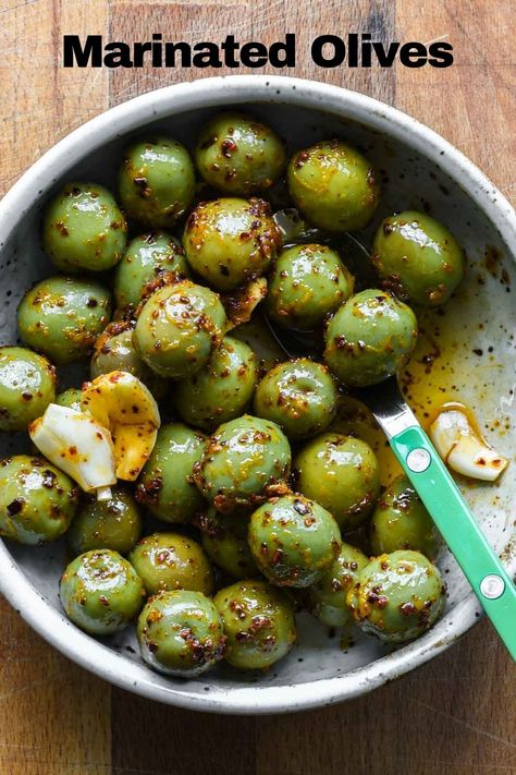 These Marinated Green Olives are a perfect snack, simple appetizer, or charcuterie board addition. They’re marinated in olive oil, orange zest, aleppo pepper, and smashed garlic – so they’re zesty, slightly smoky, and super bright. This is by far one of my favorite ways to enjoy olives. Marinated Green Olives, Green Olive Appetizer Ideas, Green Olive Recipes, Nut Free Pesto, Olive Appetizer, Cravings Recipes, Miso Chicken, Simple Appetizer, Olive Oil Bread