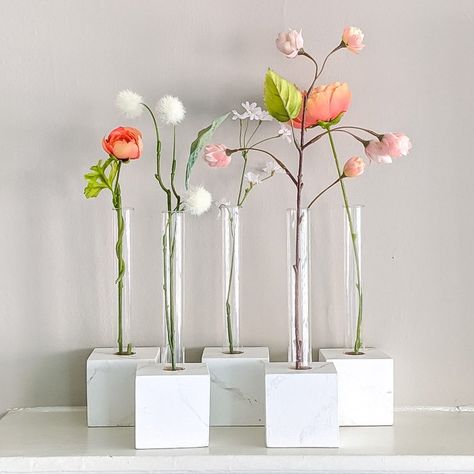 We made these Test Tube Vases for the mantel in our daugher's first apartment. She wanted a faux marble base for the vases, so we used the technique we've previously used for the faux technique. We rather made this up as we went along, having to improvise along the way. But we were all thrilled with the end result. Here’s what we used to make the test tube vases: Test Tubes, 25mm by 200mm 3″ Wood BlocksWhat You’ll Need To Marbleize the BlocksAcrylic paint for the base color of the bl… Faux Marble Countertop, Test Tube Vase, Unique Garden Art, Marble Console Table, Easy Diy Decor, Striped Vase, Tube Design, Test Tubes, Craft Decor