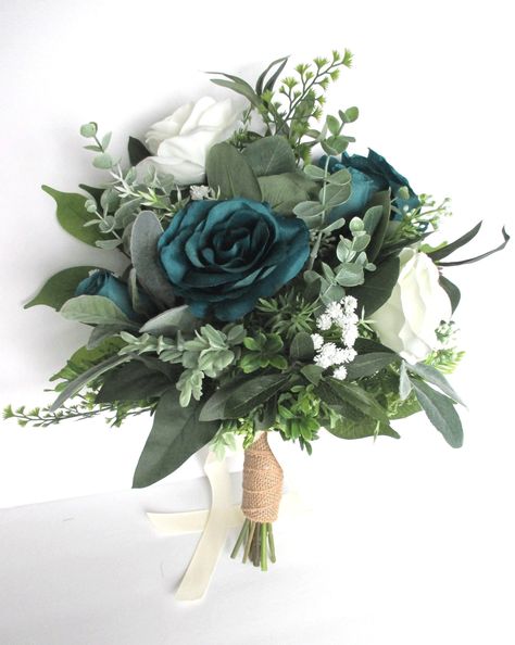 Our hand-crafted wedding bouquets are made with high quality artificial silk flowers, faux greenery and luxurious ribbons. This bouquet set is made with Faux Greenery: Eucalyptus green leaves, Boxwood green, Ferns, Pea Leaves and Berries, Lamb's Ear, Cream baby's breaths, more greenery and fillers accented with 4 Roses in Teal and ivory. The natural stem handle is wrapped in Burlap and decorated with an ivory satin bow. The Maid of honor (3 Roses with greenery), Bridesmaid (2 roses with greenery Orange Lavender Wedding, Bridal Bouquet Greenery, Teal Wedding Bouquet, Teal Wedding Flowers, Dark Teal Weddings, Teal Bouquet, Bouquet Greenery, 4 Roses, Prom Bouquet