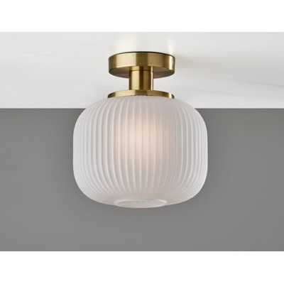 Add an elegant touch of mid-century design to your space with the Hazel flush mount light. As this light is damp location rated, it is the perfect addition to bathrooms, kitchens, and covered outdoor areas that frequently experience moisture. A cylindrical frosted ribbed glass shade emits a soft ambient glow from a 100W bulb, while the 5" diameter base in an antique brass finish adds to the clean, modern design. Complete your décor with the coordinating Hazel pendant light, floor lamp, and table Lightning Ideas, Sea Gull Lighting, Flush Mount Lights, Flush Mount Light, Ribbed Glass, Mount Light, Lighting Store, Bright Lights, Glass Texture