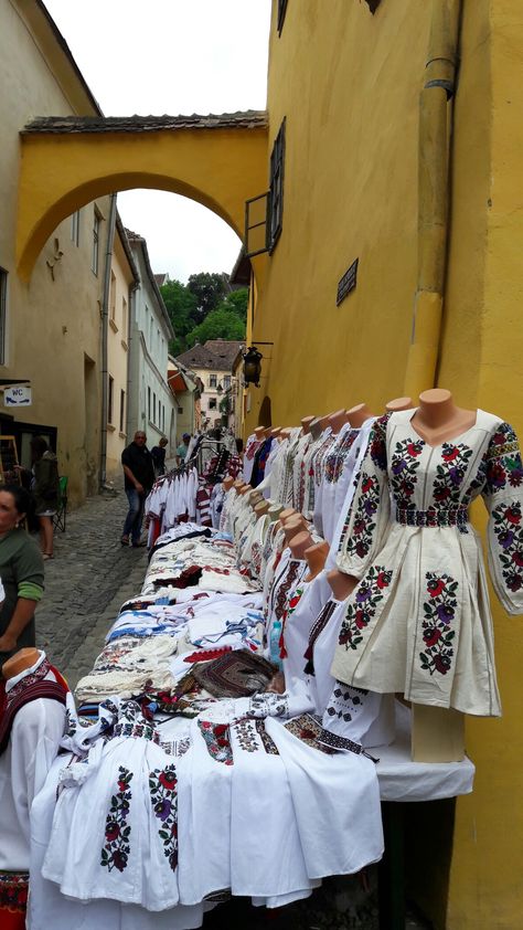 Romanian Street market selling traditional Romanian clothing Romania Traditional Clothes, Romanian Culture Aesthetic, Romanian Summer Aesthetic, Romania Clothes, Romanian Summer, Traditional Romanian Clothing, Romanian Traditional Clothing, Romanian Aesthetic, Serbian Wedding