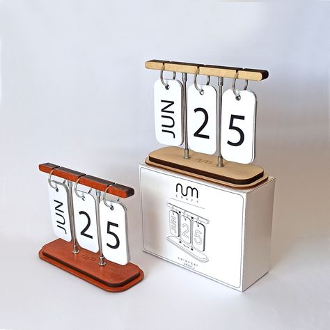 "Wood & metal perpetual desk calendar. FEATURES It's a wooden based perpetual desk calendar with flip-over cards. A functional and decorative accessory for your home or office.  Great piece as an office gift. It's available in various colors to make the best combination for your environment. MATERIAL Birch plywood. Metal. Bristol Paper. VARIATIONS Oak is teak oiled. Walnut is varnished with water based varnish. Colored ones are painted with acrylic. It comes with 6 finish options. * oak (light w Calendar Wood, Pink Office Decor, Small Calendar, Block Calendar, Table Calendar, Office Desk Storage, Laser Cut Wood Crafts, Online Calendar, Diy Calendar