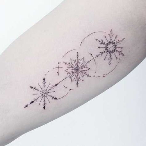 25 Snowflake Tattoo Ideas: Channeling the Beauty of Winter's Delicacy Snowflake Tattoo Women, Snowflake Tattoo Back Of Neck, Snowflake Arrow Tattoo, 3 Snowflake Tattoo, Tattoo Ideas Snowflake, Snow Flake Tattoos For Women, Snowflake Fine Line Tattoo, Winter Tattoo Ideas Snow, Ornamental Snowflake Tattoo