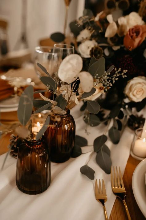 Centrepiece Flowers Decor Glass Jars White Rose December Wedding Ideas Megan Donati Photography #wedding #centrepiece #weddingflowers Table Decor Wedding Boho, Rustic Boho Wedding Table Centerpieces, Amber Glass Fall Centerpiece, Brown Glass Wedding Centerpieces, Big Clear Vase Decor Ideas, Brown Wedding Table Decor, December Wedding Decor, Wedding Decor 2024, Candles Centerpiece Wedding