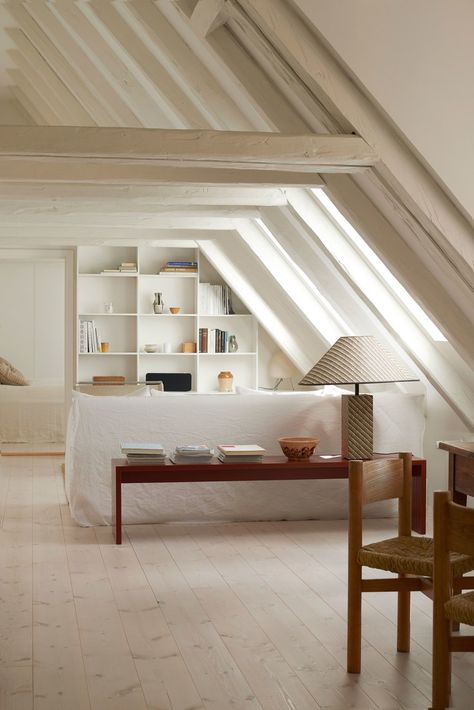 A look into the living room shows the whitewashed angled wooden beams that create spectacular visual lines over the... Copenhagen Apartment, Townhouse Apartments, Attic Apartment, Attic Bedrooms, Attic Renovation, Attic Remodel, Apartment Renovation, Attic Bedroom, Attic Rooms