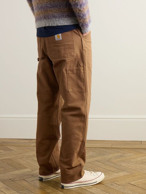 Carhartt WIP leans into utilitarian workwear with its 'Double Knee' trousers. Cut from a mid-weight cotton-canvas, they're reinforced with panels on each leg and sewn together with bar tack stitching along high-stress points for extra durability. Finishing touches include tool pockets and hammer loops. Chore Pants Men, Workwear Pants Outfit Men, Workwear Pants Men, Carhartt Carpenter Pants Outfit Men, Streetwear Pants For Men, Carhartt Jeans Outfit Men, Mens Carpenter Pants Outfit, Carhartt Double Knee Pants Outfit Men, Carpenter Outfits Men