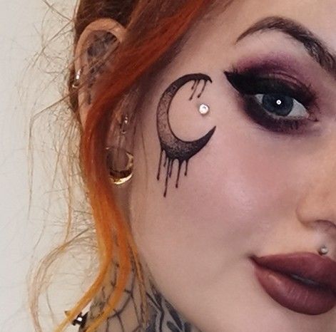 Goth Face Tattoos For Women, Feather Face Tattoo, Witchy Face Tattoo, Moon Throat Tattoo, Gothic Face Tattoo, Witchy Neck Tattoo, Face Tats For Women, Goth Neck Tattoo, Moon Tattoo Face